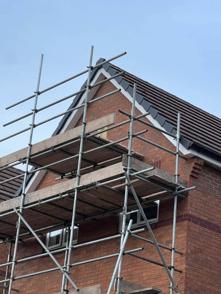 This is a photo of a roof which has just been repaired. There is a scaffold located at the gable end for access onto the roof. Works carried out by Thurmaston Roofing Repairs